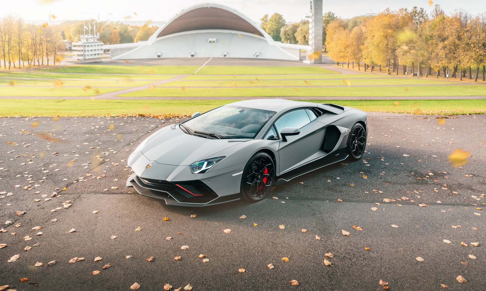 A silver lamb lamb car parked in front of a building (lamborghini aventador lp 780 4 ultimae, 5k, 2021, cars, 4k wallpaper)