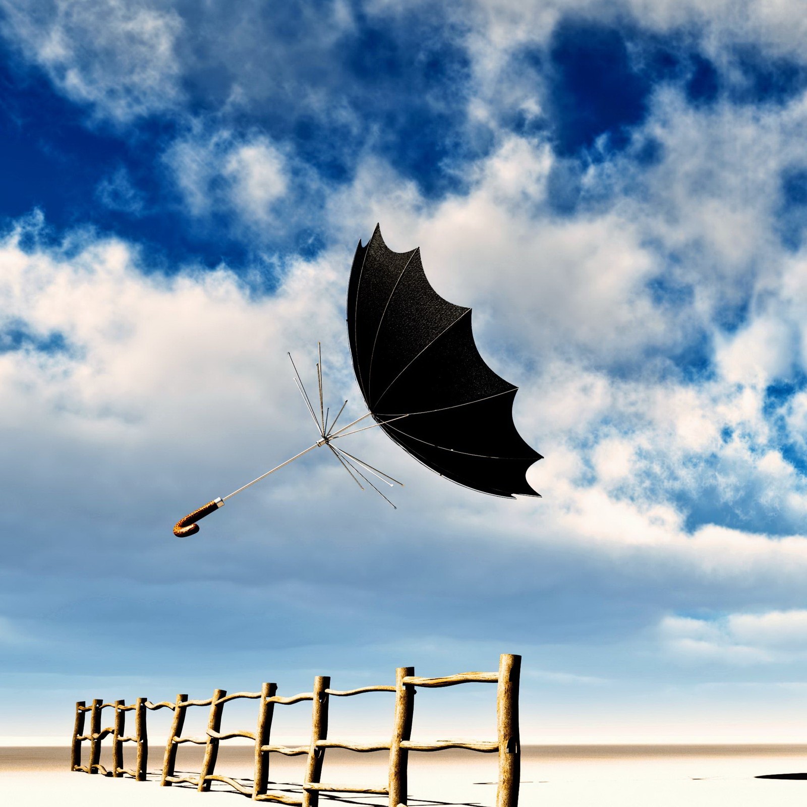 Il y a un parapluie noir qui vole au-dessus d'une clôture sur la plage (volant, parapluie)