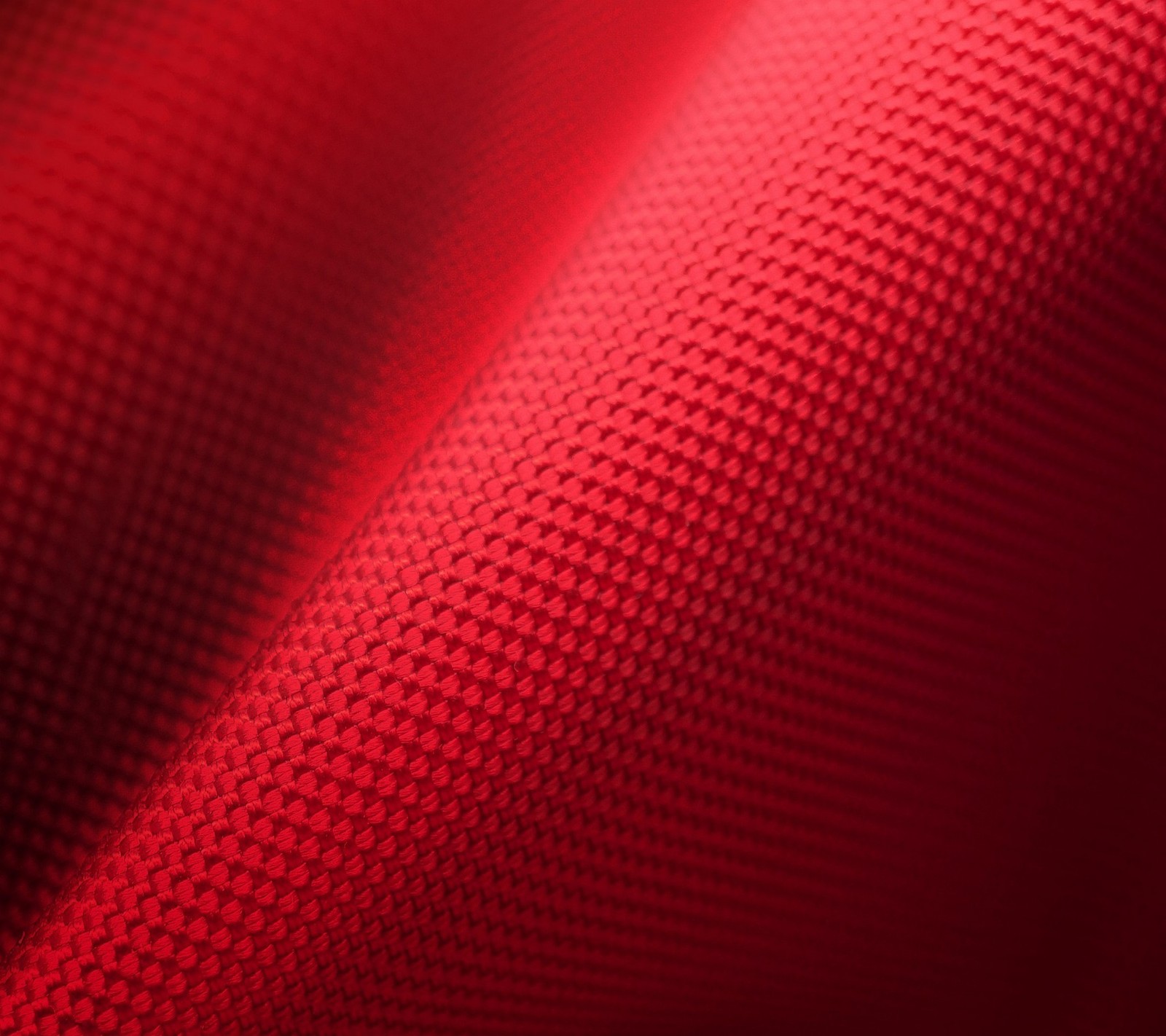 A close up of a red fabric with a black background (canvas, fabric, nylone, red)