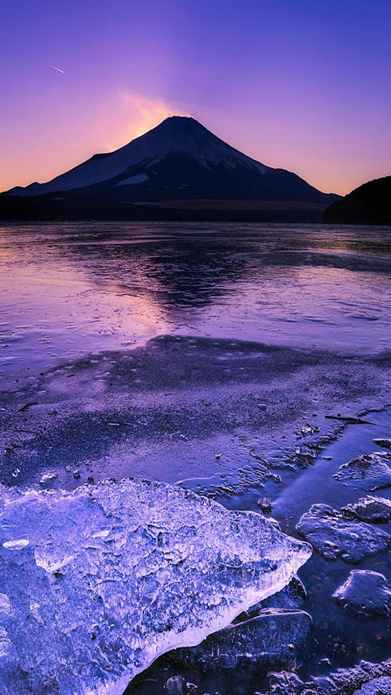 Фиолетовое небо над горой и замерзшей водой (море, побережье)