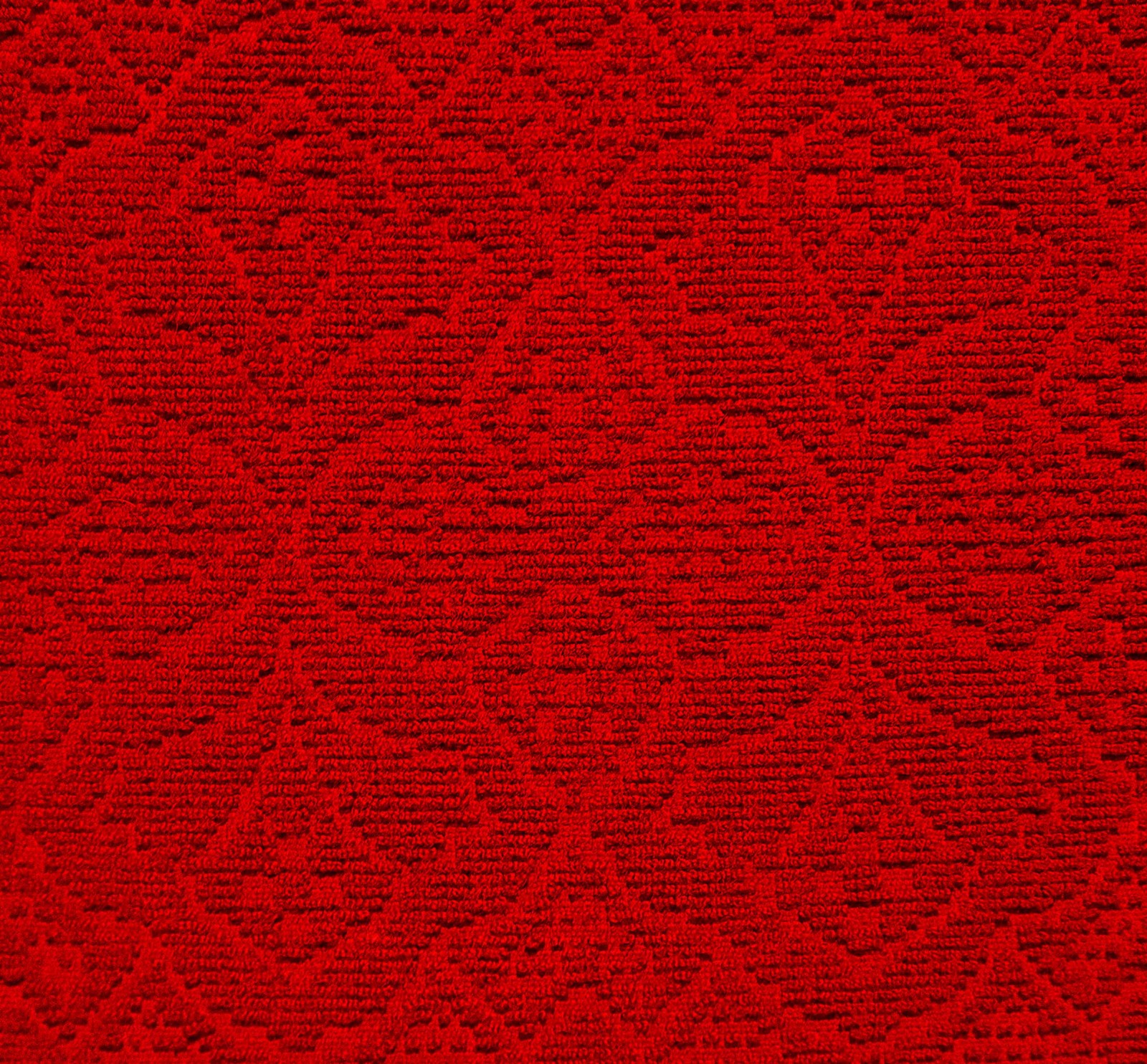 Un gros plan d'un tapis rouge avec un motif en losanges (motif, textile, rouge, laine, en laine)