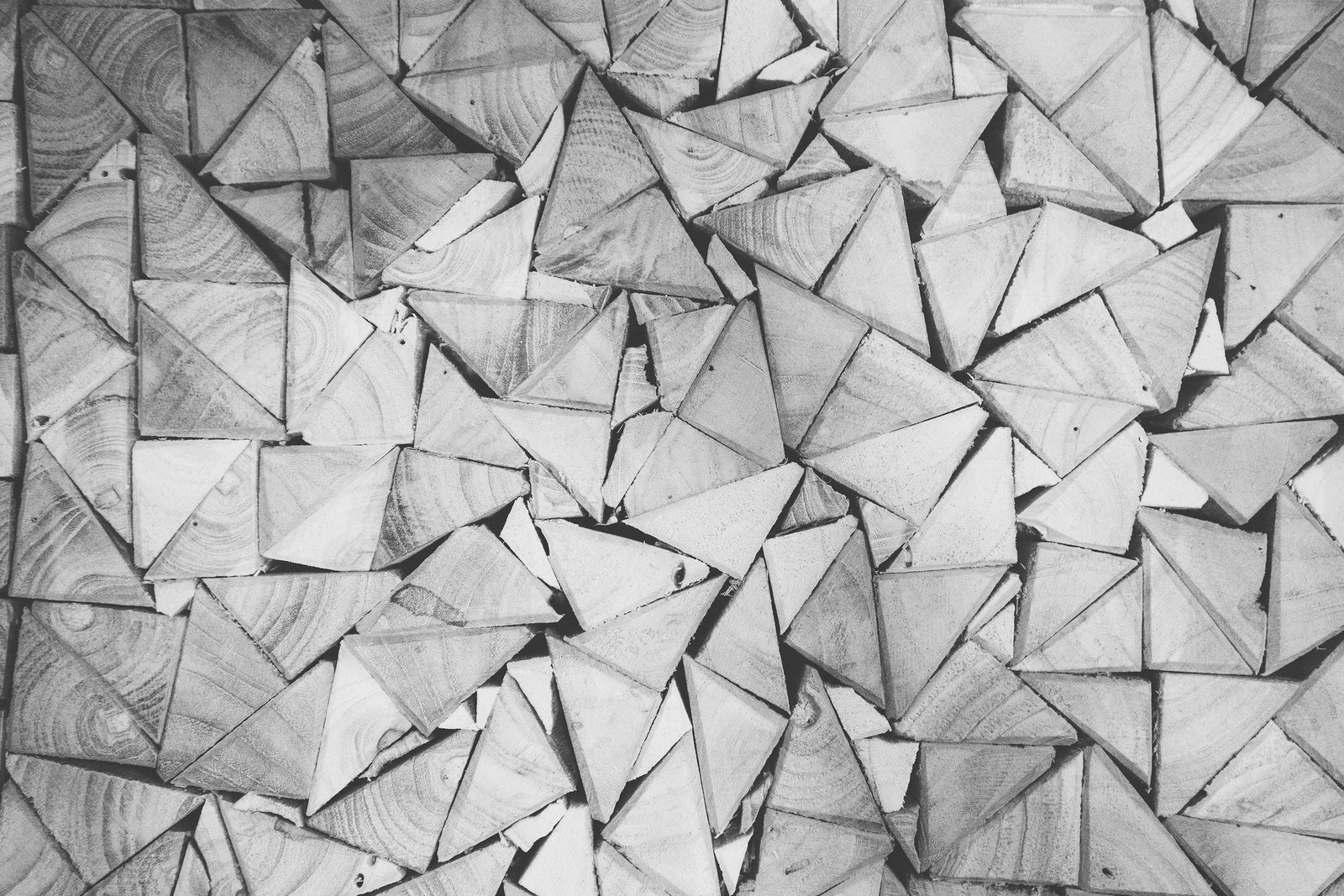 A close up of a pile of wood with a black and white photo (pattern, black and white, line, design, monochrome)