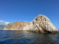 Formations rocheuses majestueuses au bord d'un lac serein contre un horizon dégagé