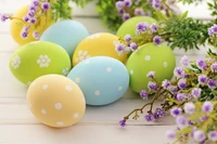 Colorful Easter eggs surrounded by vibrant flowers.