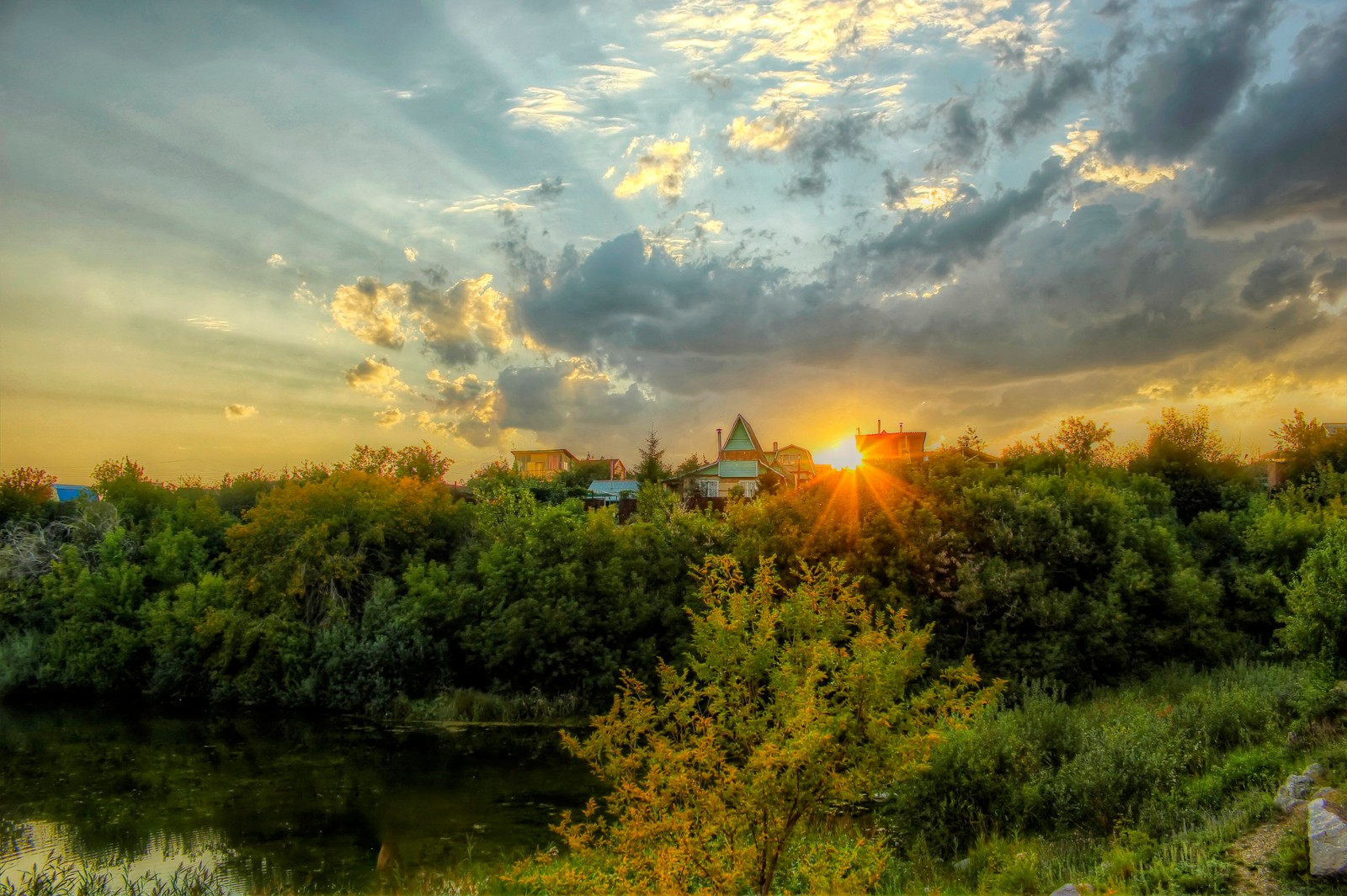 Arafed view of a sunset over a river with a building in the distance (morning, nature, cloud, sunrise, dawn)