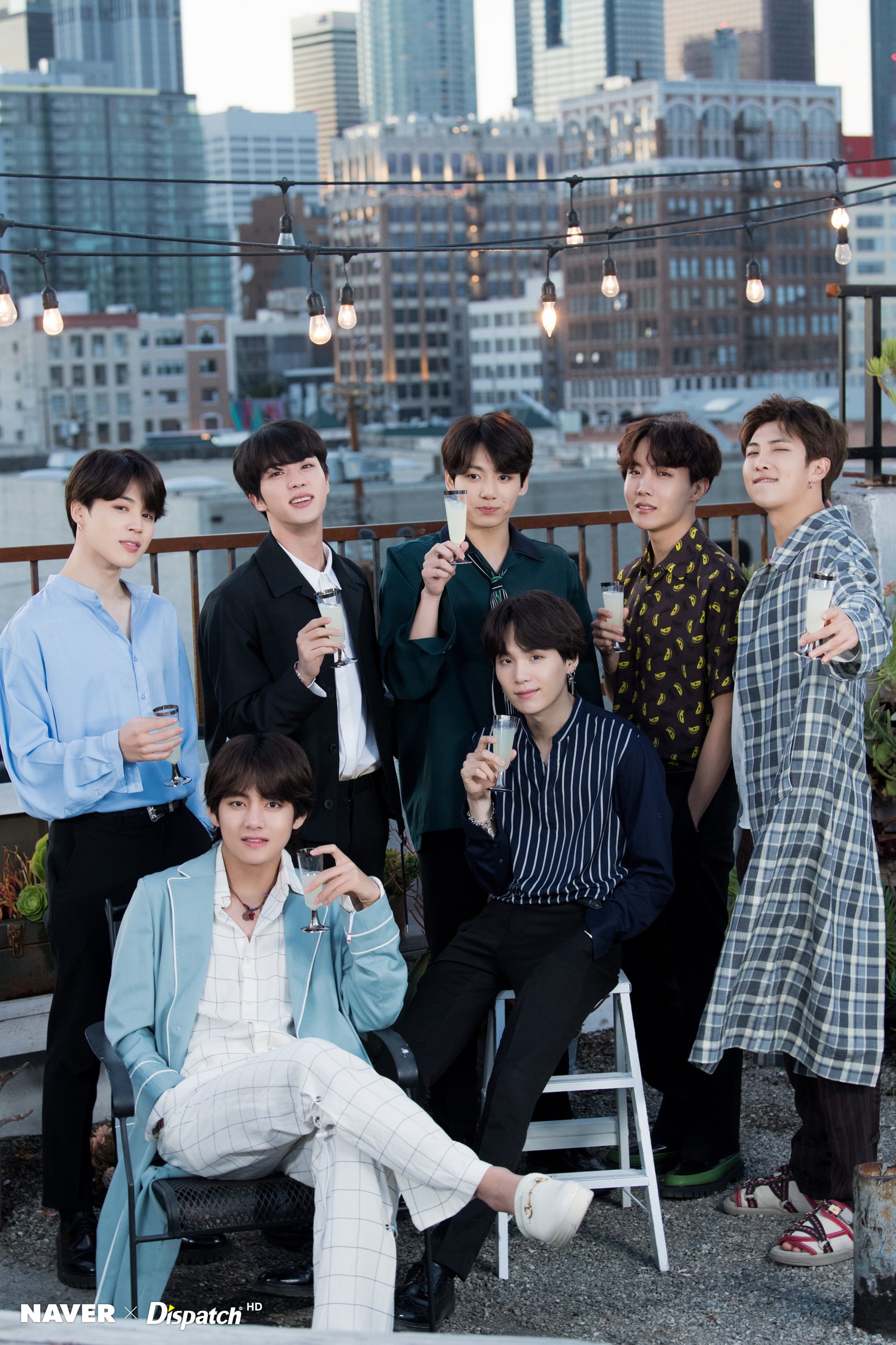 There are many people posing for a picture on a rooftop (bangtan sonyeondan, bts, j hope, jimin, jin)