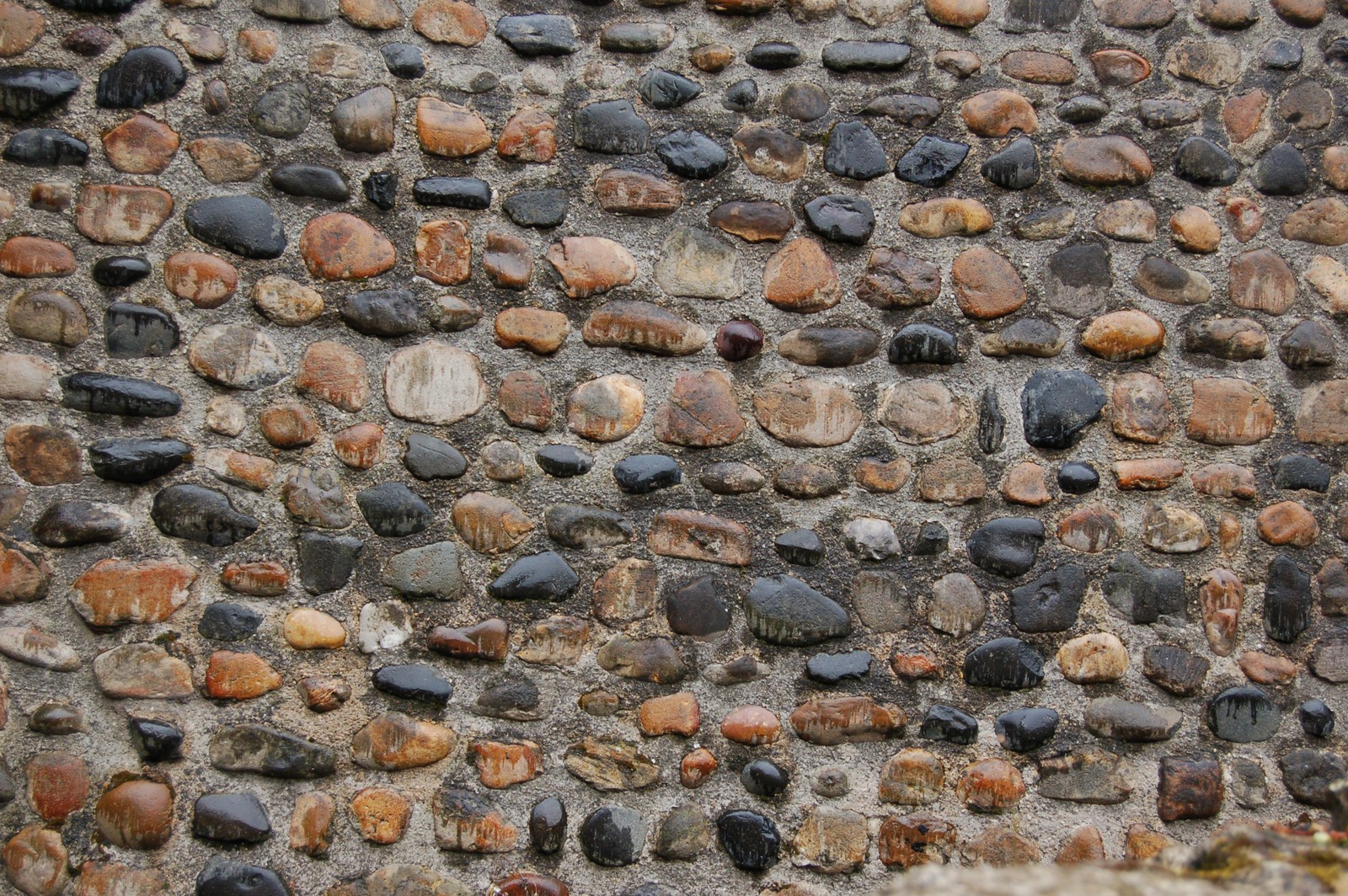 Arafed stone wall with small stones and small stones on it (stone wall, texture mapping, gravel, pebble, wall)