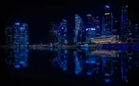 Illuminated Cityscape Reflected on Water at Night