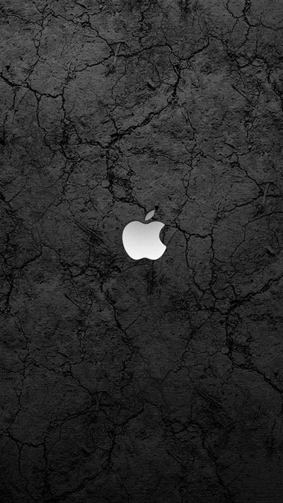 Monochrome Apple Logo Against a Dark, Cracked Background