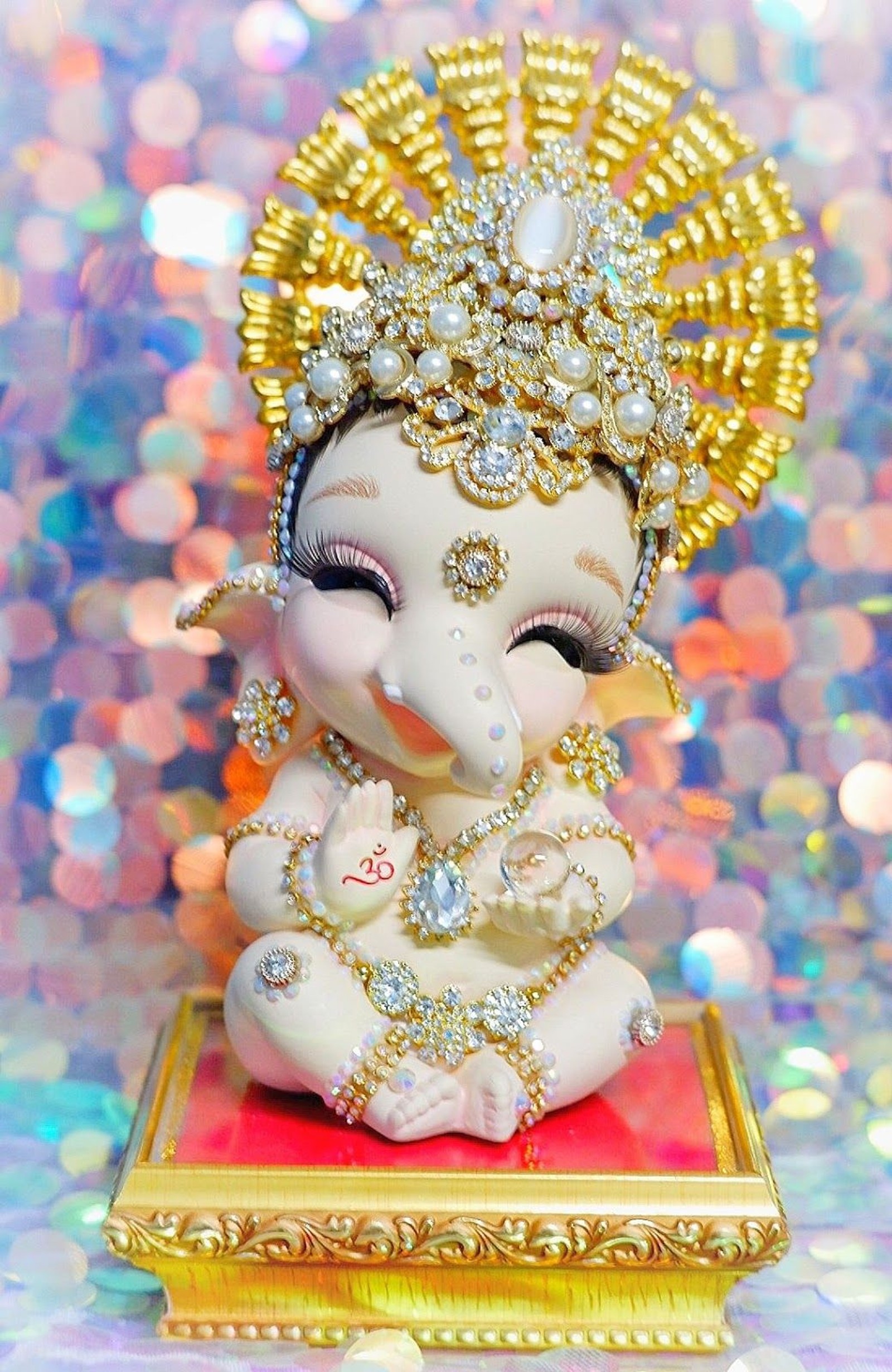 A close up of a small statue of a baby gan (balganesh, cuteganesh, lord, love, spiritual)