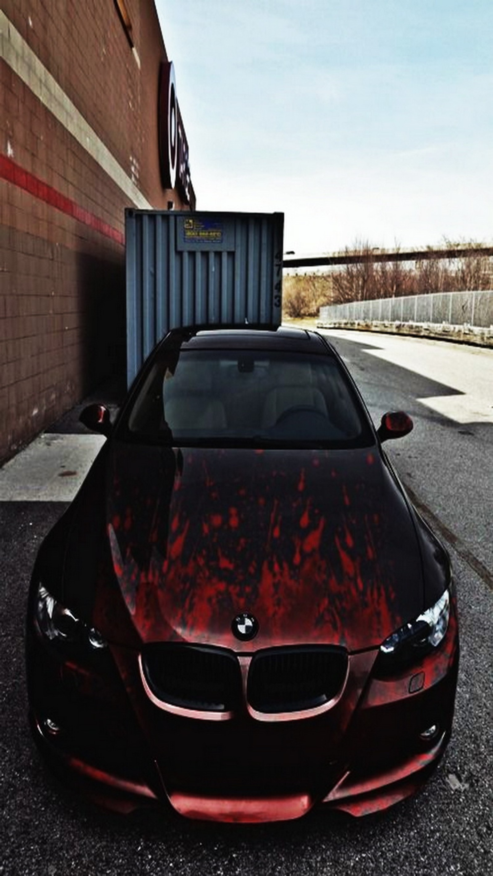 Arafed bmw car parked in front of a building with a trash can (black, blood, bmw, red)