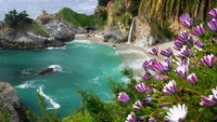 Tranquil Coastal Cove with Waterfall and Vibrant Wildflowers