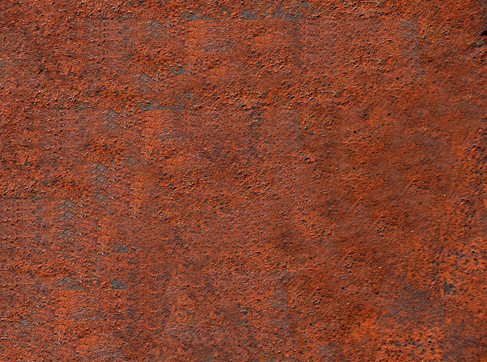 A close up of a red metal surface with a black hole (wood stain, brown, rust, pattern, material)