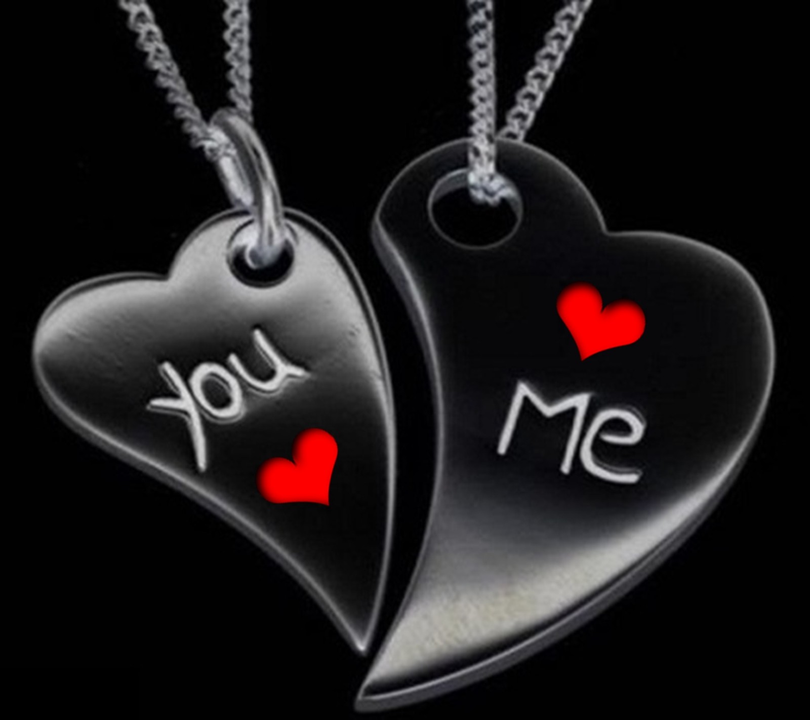 Two black heart shaped necklaces with red hearts on them (and me, you)