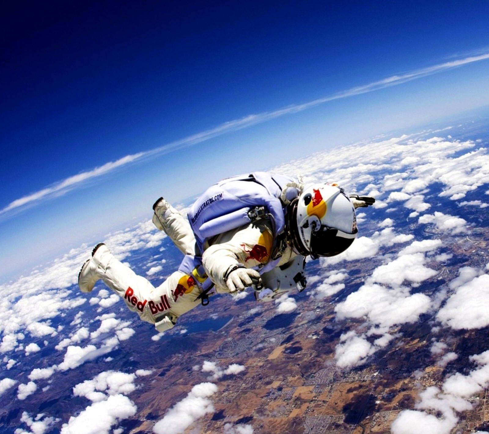 Arafed man in a white suit is flying through the air (astronaut, extreme, felix, red bull, sky)