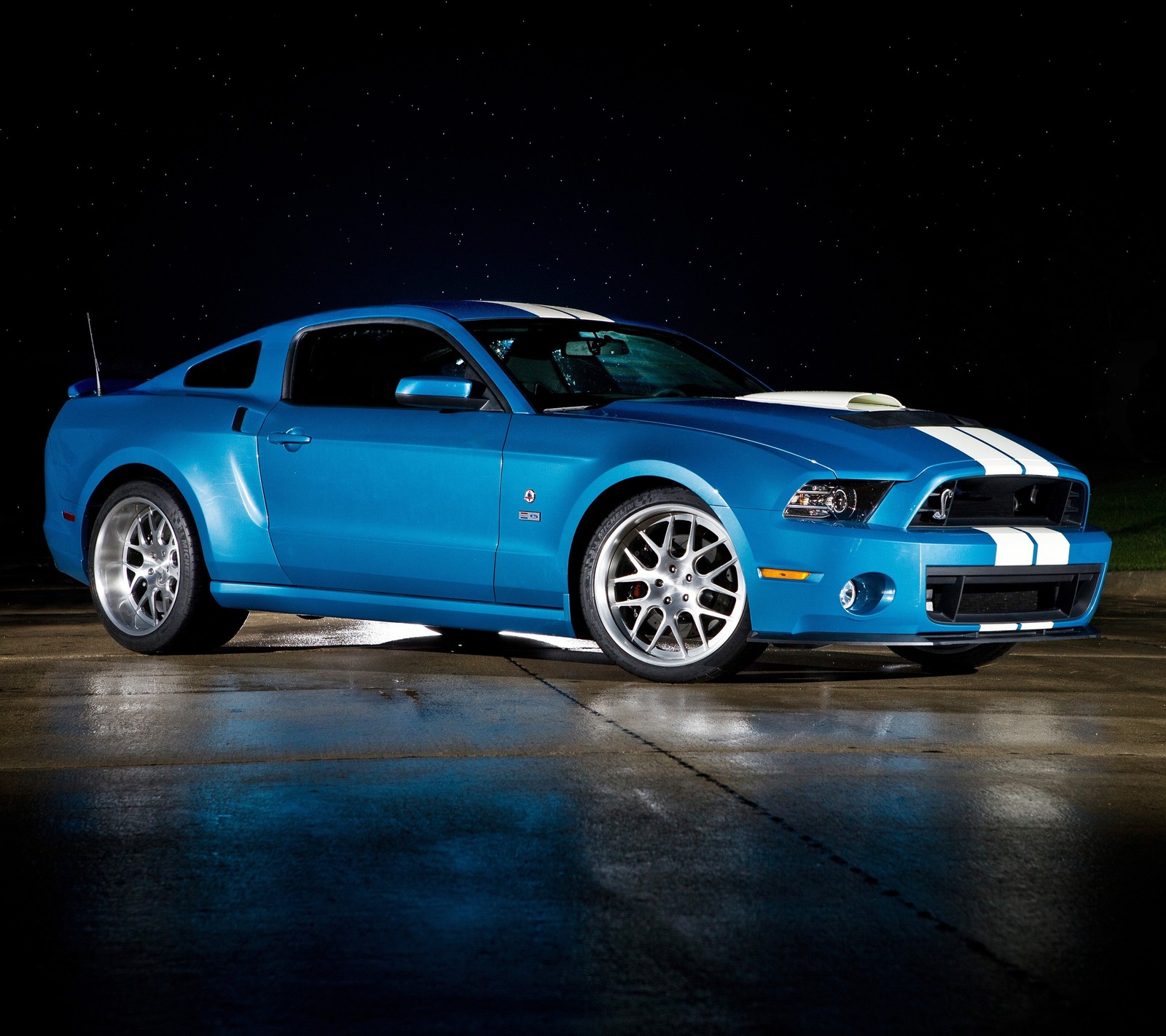 A close up of a blue mustang parked in a parking lot (auto, car, cobra, ford, mustang)