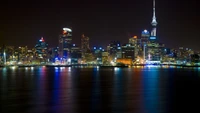 Vibrant Night Skyline of a Metropolis: Illuminated Skyscrapers and Reflections