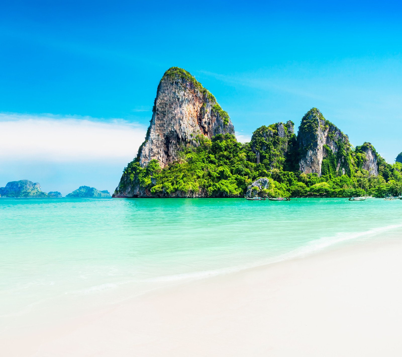 A view of a beach with a mountain in the background (island, landscape, nature, sea)