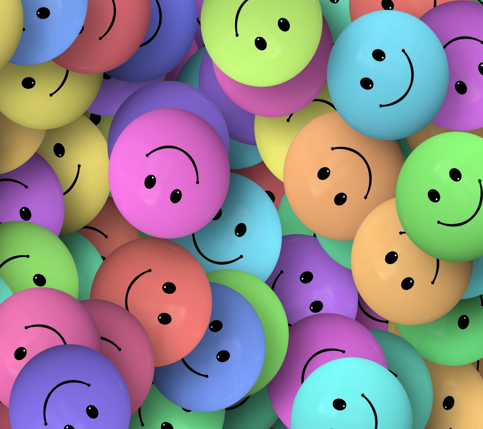 A close up of a bunch of balloons with faces drawn on them (colours, smiley)