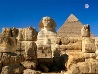 Great Sphinx of Giza with the Pyramid in the background under a clear blue sky.