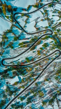 Turquoise Landscape: Winding Roads Through Snowy Terrain and Vibrant Foliage