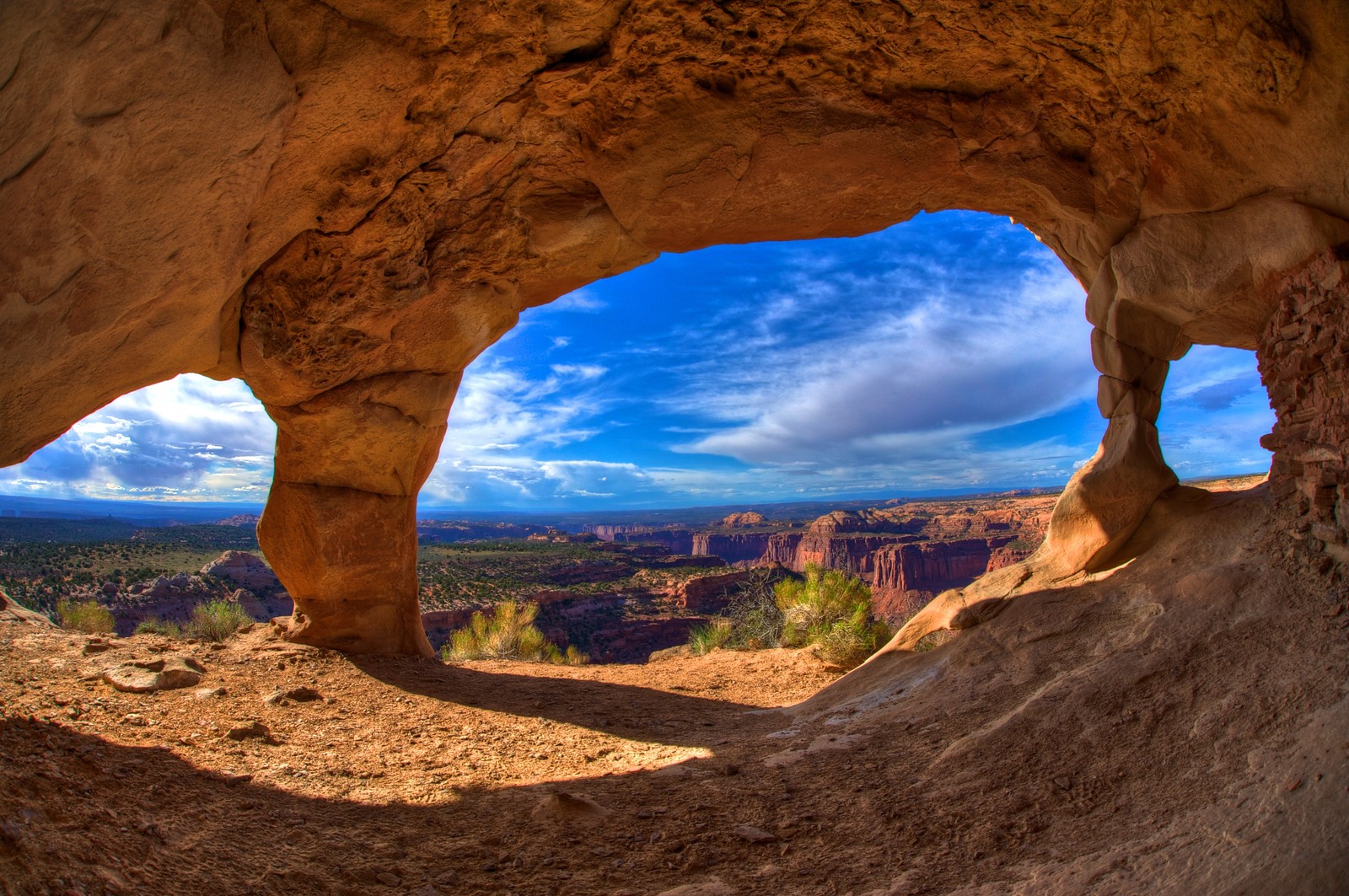 Arafed view of a canyon through a hole in a rock (natural arch, formation, arch, nature, rock)