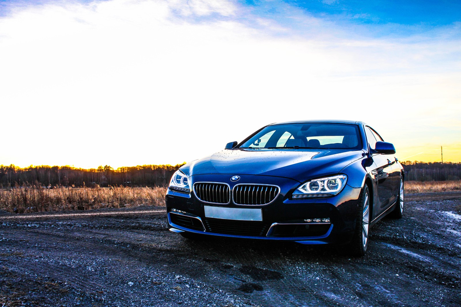 A close up of a car parked on a dirt road (bmw 6 series, car, bmw, blue, bmw m3)