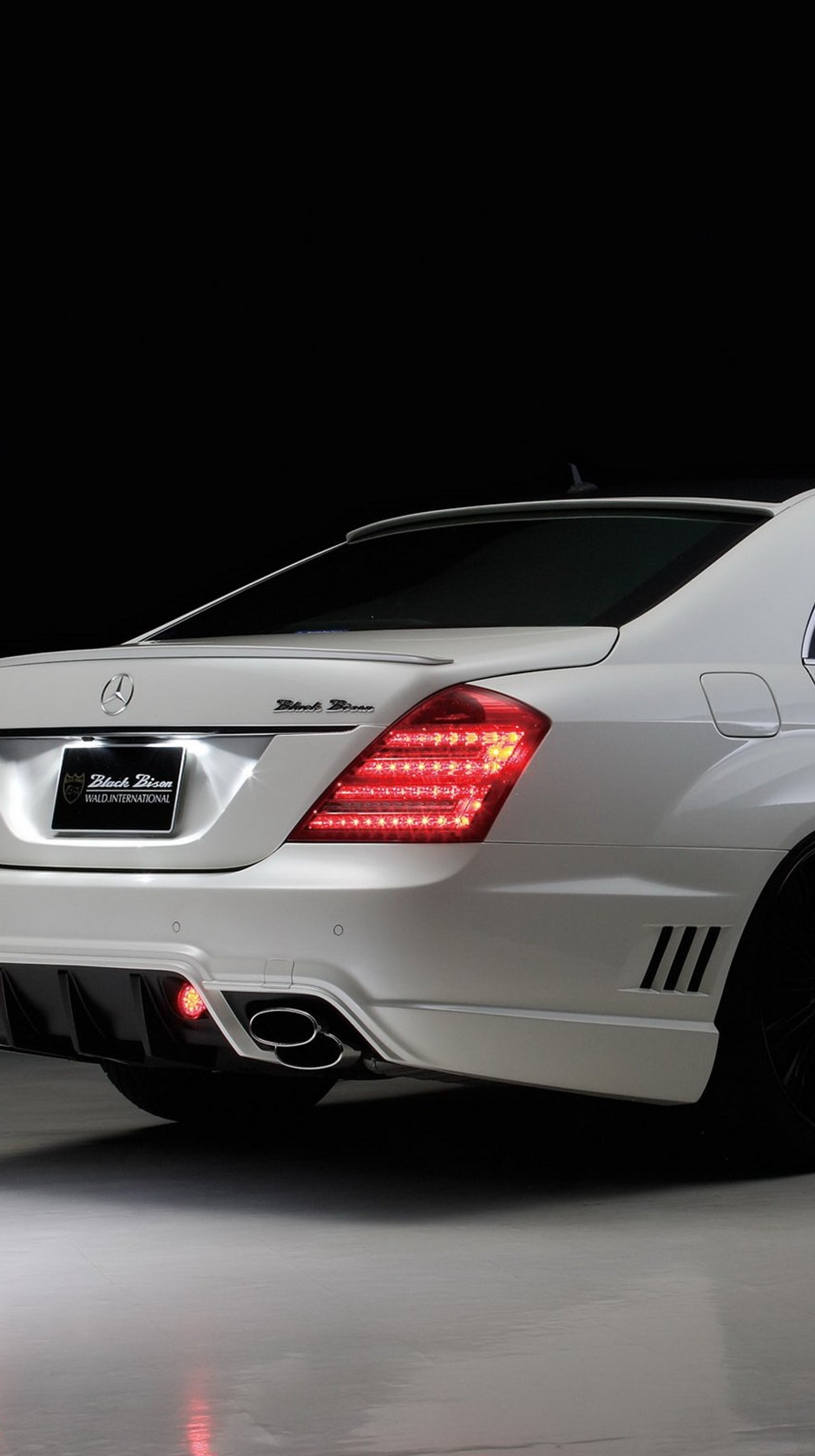 A close up of a white mercedes s - class parked in a garage (amg, benz, mercedes)