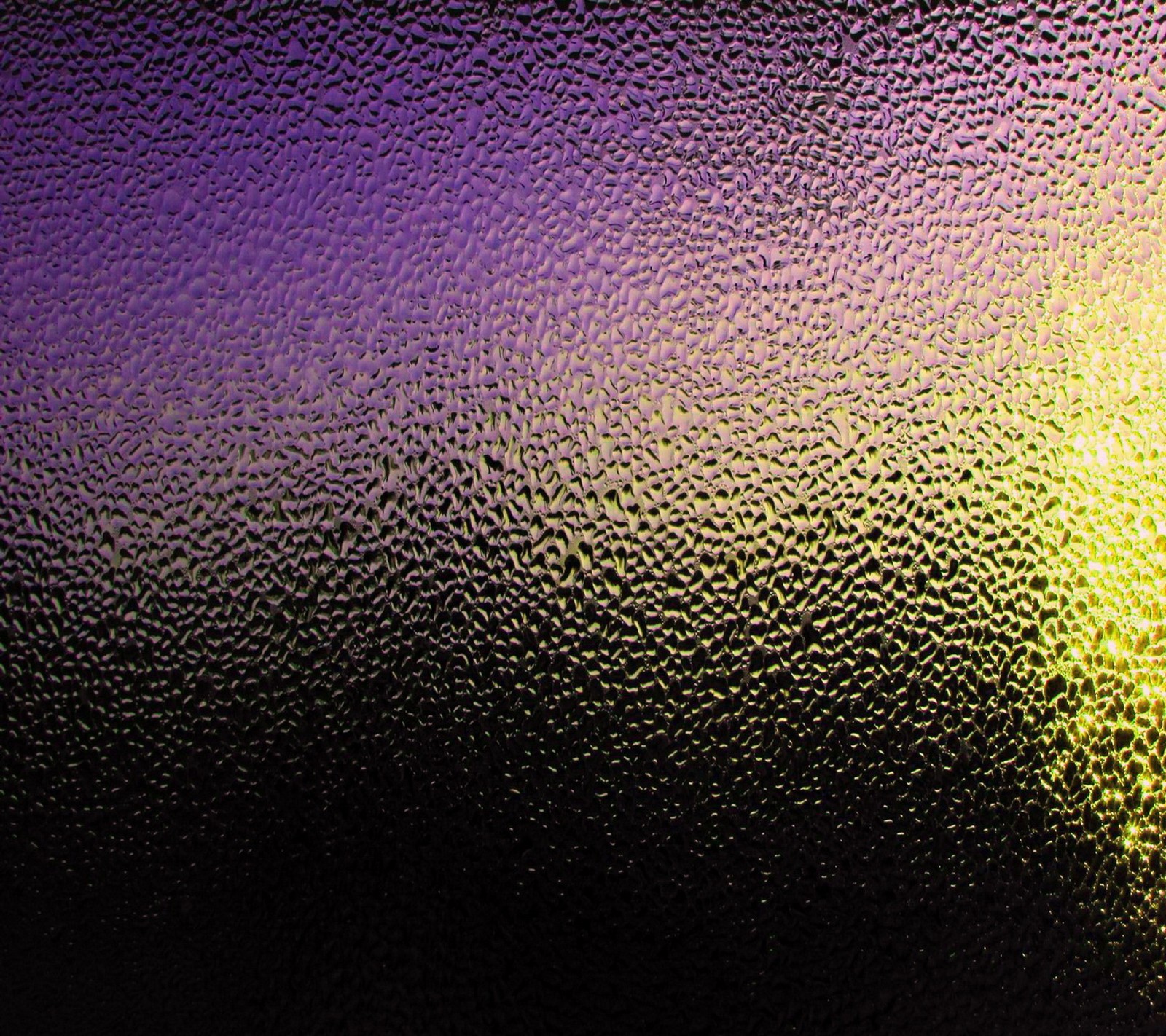 A close up of a glass with a yellow and purple background (black steel, surface pattern, texture wet)