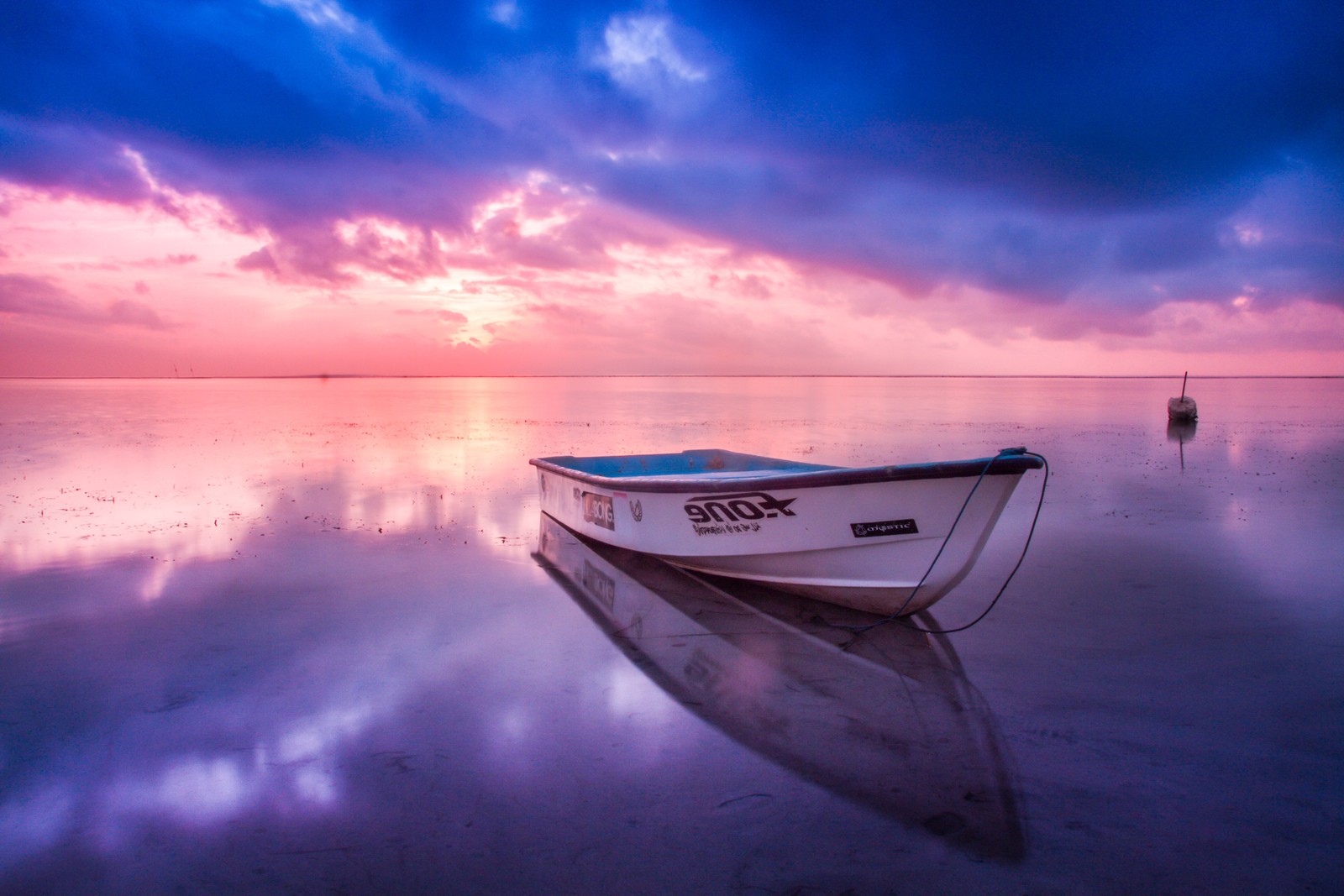 Bateau arafé sur l'eau au coucher du soleil avec un fond de ciel (mer, océan, plage, vague, la côte)