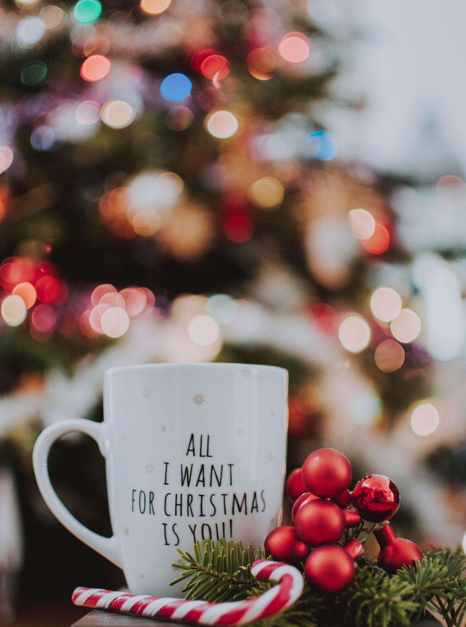 There is a coffee cup with a christmas message on it (cup, coffee cup, christmas, mug, christmas eve)