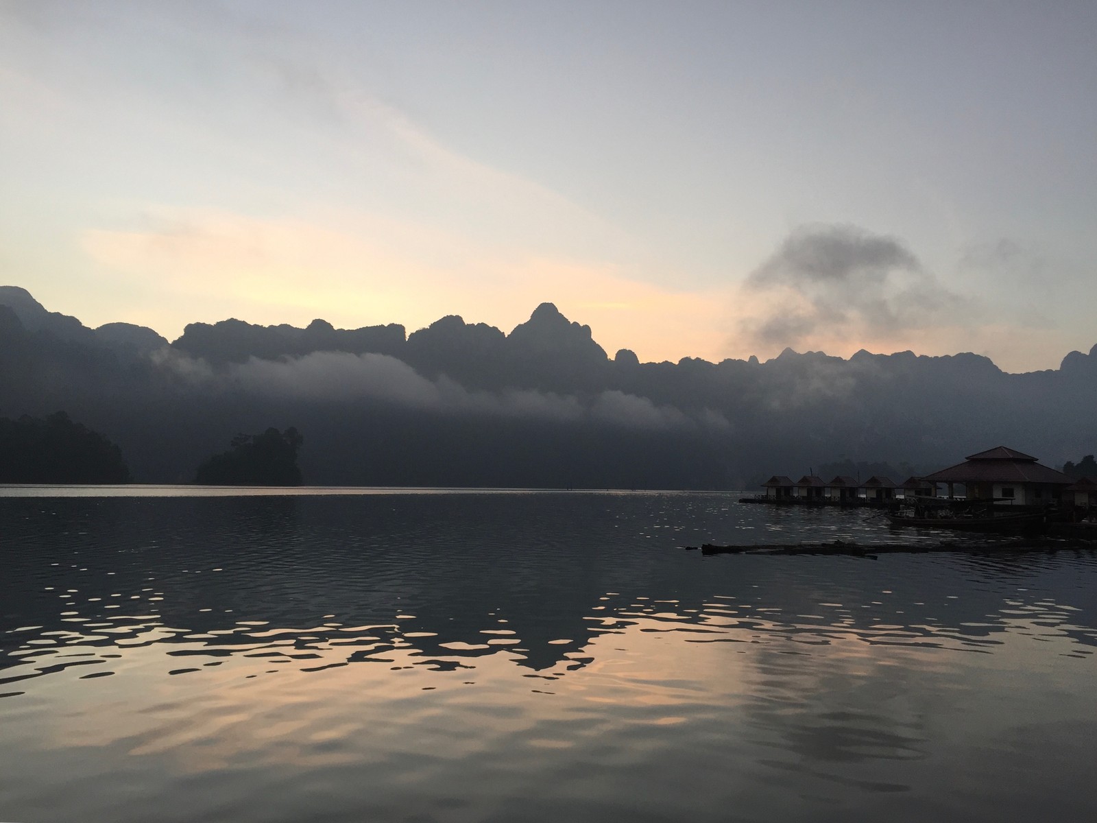 There is a boat that is sitting on the water in the water (reflection, water, liquid, water resources, fluid)