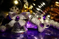 Glittering silver and purple Christmas bells surrounded by festive decorations, capturing the spirit of holiday cheer.