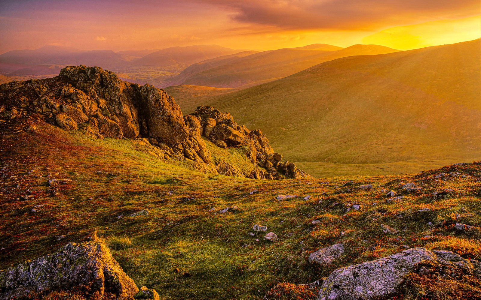 A view of a mountain range with a sunset in the background (mountainous landforms, nature, highland, hill, fell)