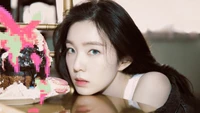 Irene from Red Velvet poses with a colorful, artistic cake for her birthday celebration.