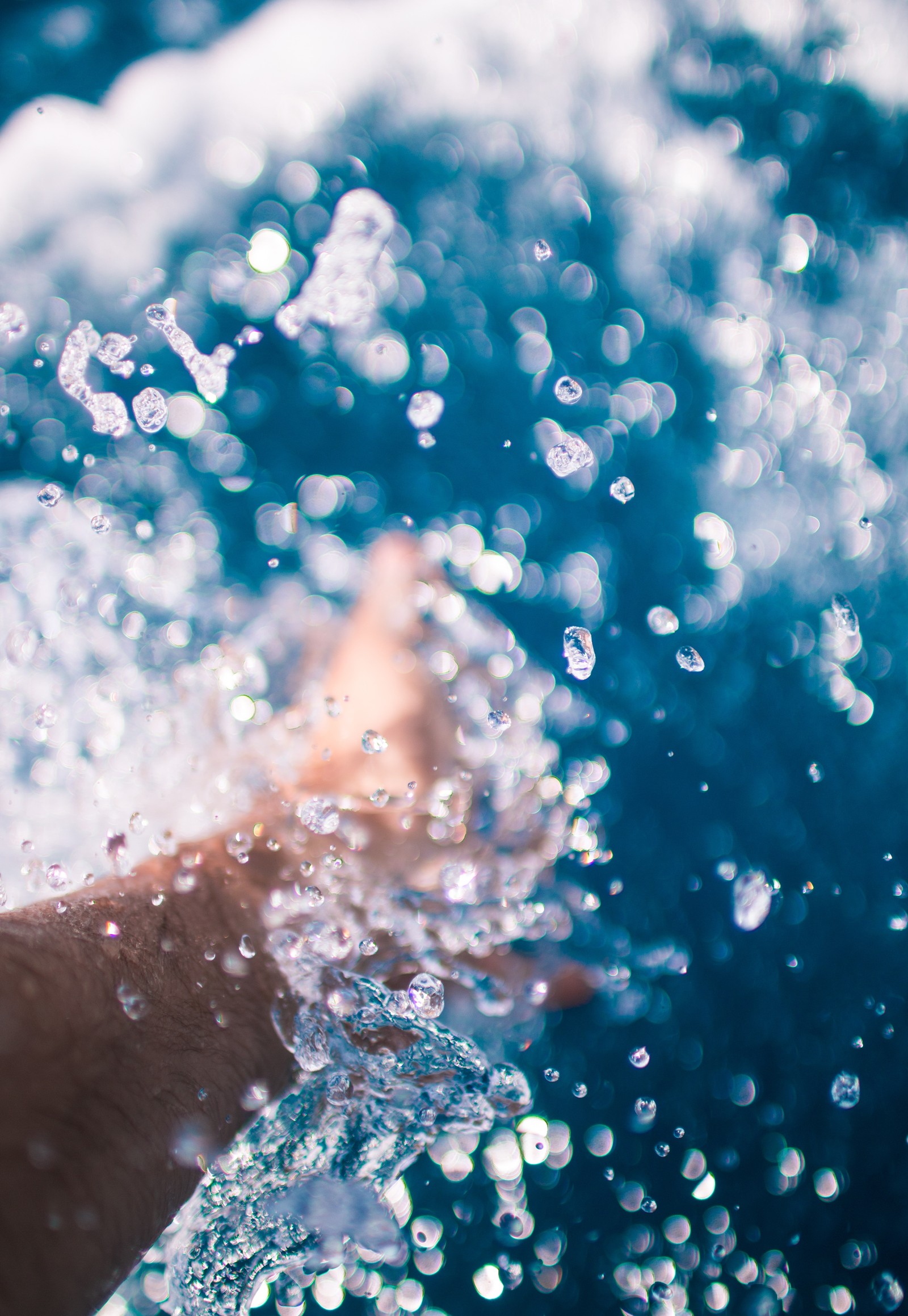 Someone is swimming in the water with their feet in the water (water, blue, liquid bubble, turquoise, cloud)