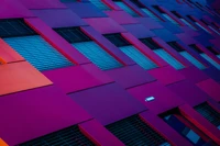 Geometric Patterns on a Purple-Faced Building in Low Angle Perspective