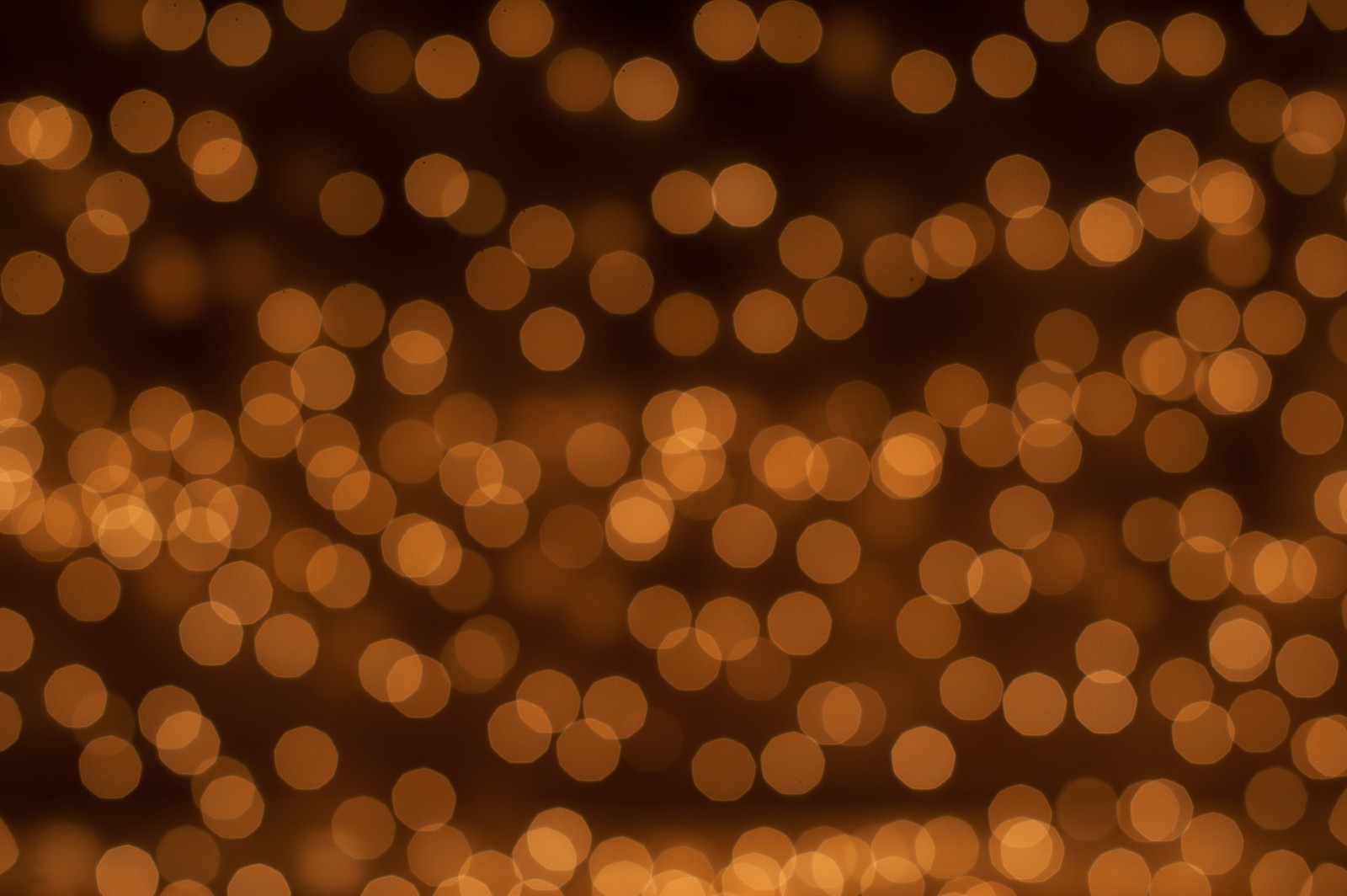 A close up of a blurry background of lights (pattern, orange, light, lighting, circle)