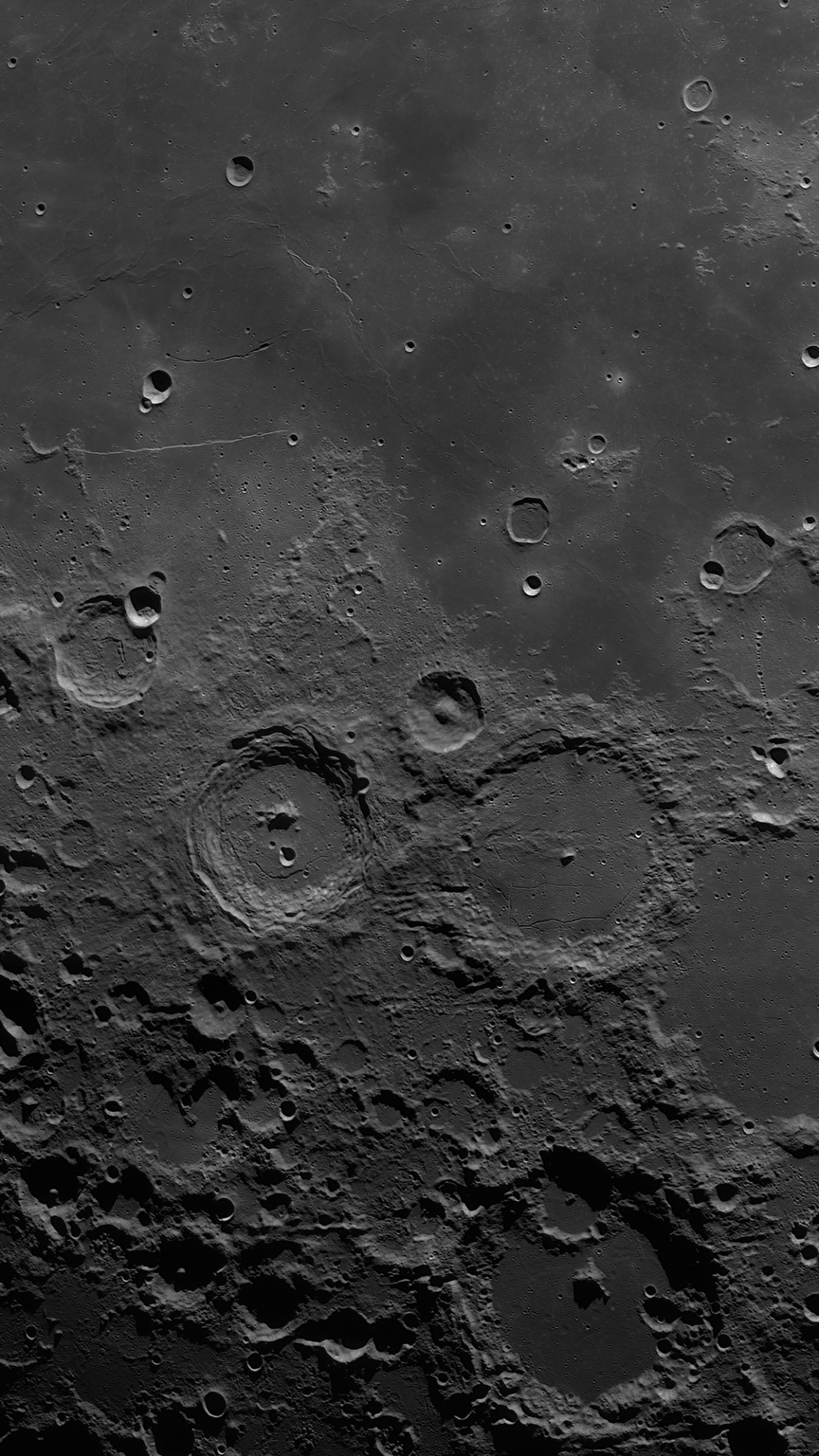 A close up of a black and white photo of the moon (moon, water, space, grey, black and white)