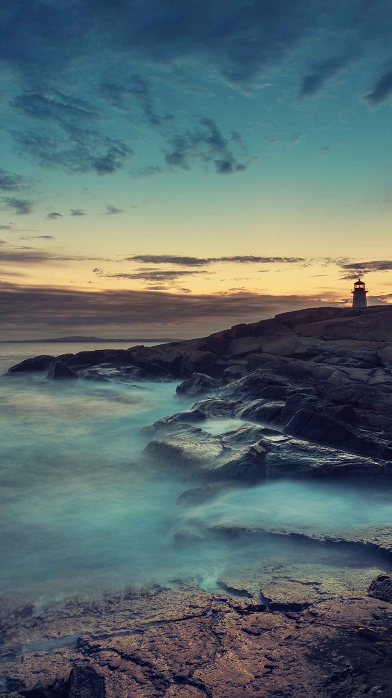 Arafed view of a lighthouse on a rocky shore at sunset (2013, sony, xperia z)