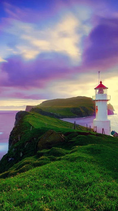 Coastal Serenity: A Lighthouse Amidst Lush Green Cliffs