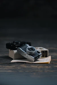 Close-Up of Digital SLR Cameras on an Open Book