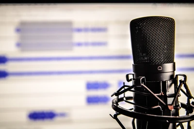 Studio Microphone with Audio Waveforms in Background