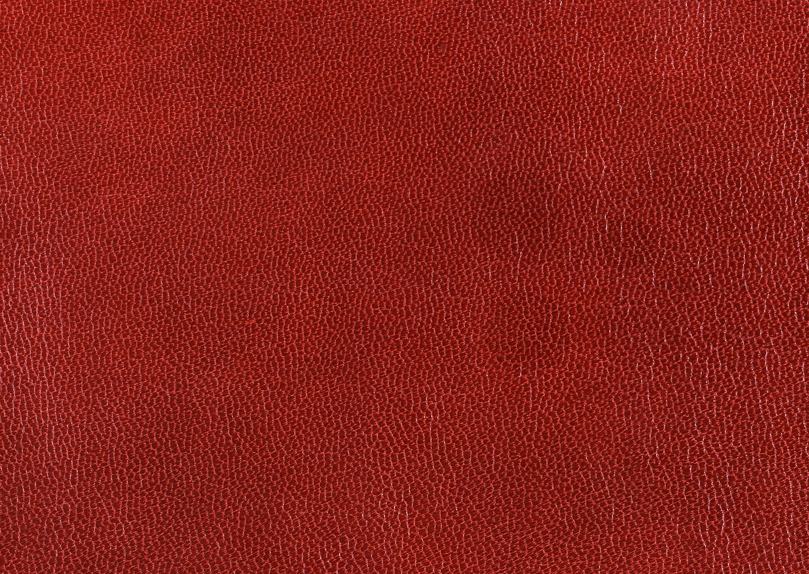 Un primer plano de una superficie de cuero rojo con algunas rayaduras (cuero, marrón, rojo, color, textura)