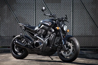 Sleek Black Harley Davidson Café Racer Against a Fenced Background