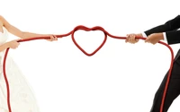 Symbol of Love: Engaged Couple Holding a Heart-Shaped Rope