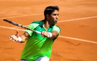 Tennis player in action on a clay court, demonstrating skill and focus during a match.