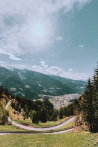 Winding Road Through a Stunning Mountain Landscape Under a Bright Sky