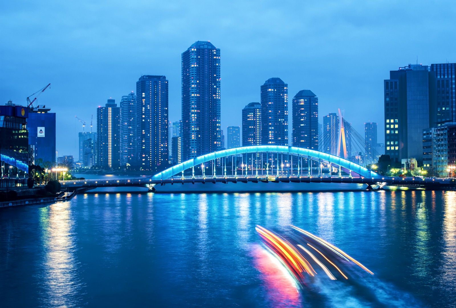 Um barco na água com uma ponte e uma cidade ao fundo (cidade capital, arranha céus, cidade, paisagem urbana, linha do horizonte)