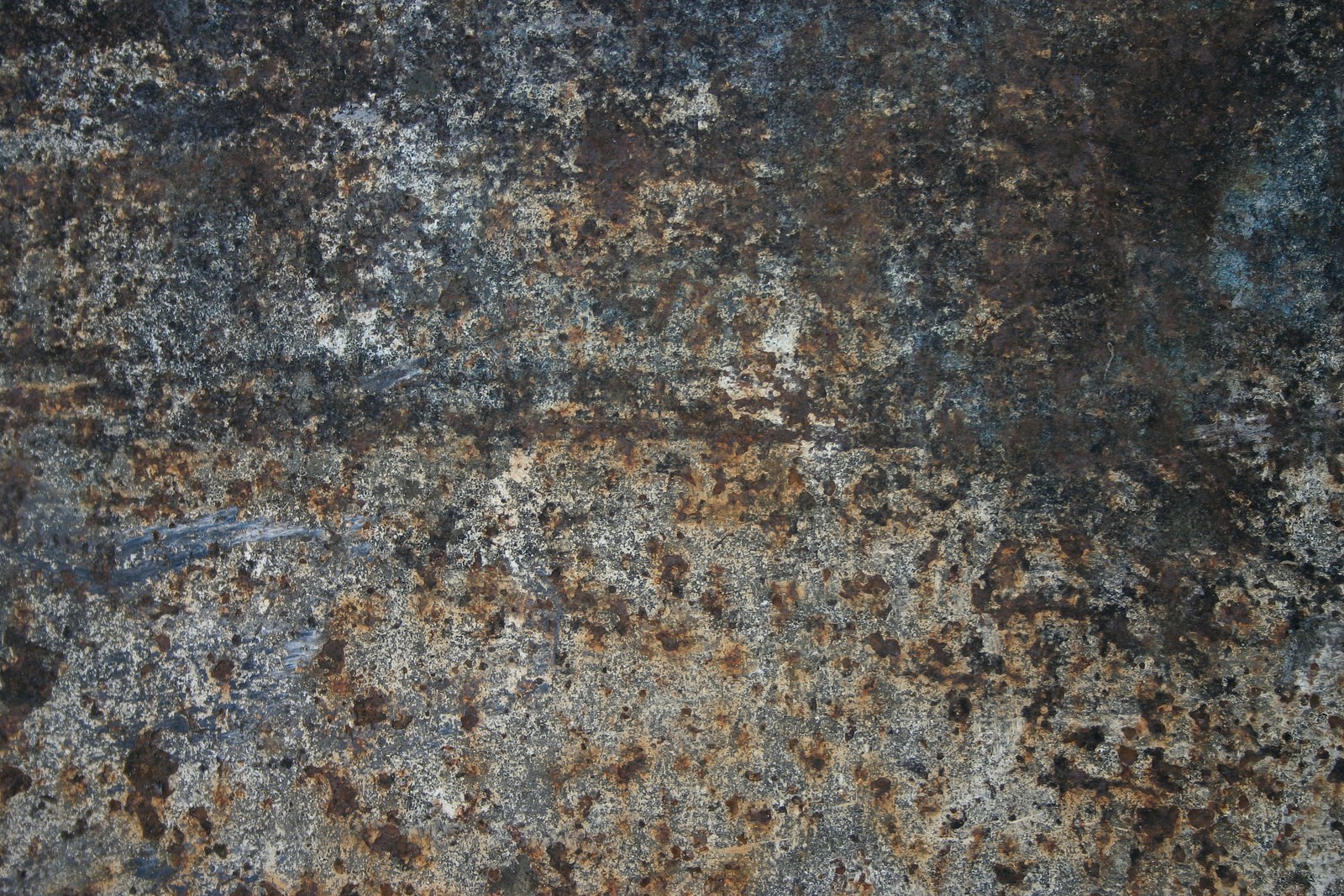 A close up of a rusty surface with a lot of rust (granite, texture, rock, geology, metal)